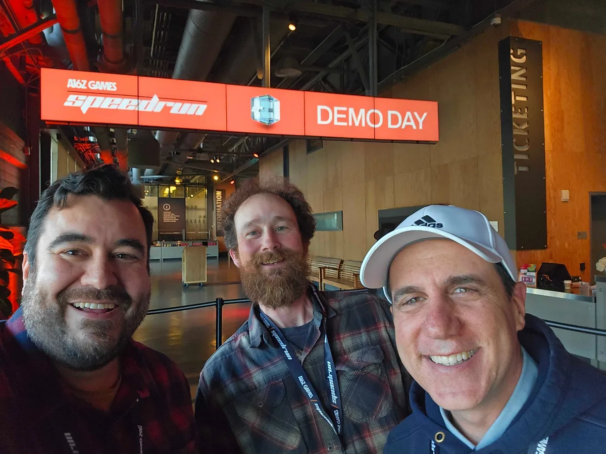 Nathan Wheeler, David Berger and Sean Vesce at an a16z Games Speedrun demo day, standing together under the Speedrun Demo Day sign.
