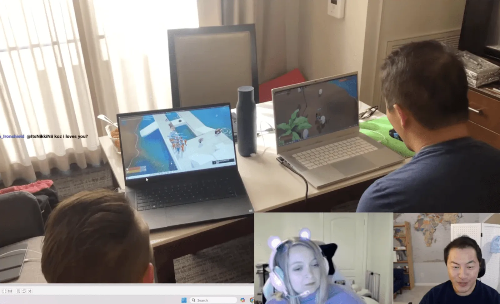 Two playtesters sharing a laptop to play Voyagers of Nera at a kitchen table, with two more participants visible in webcam thumbnails in the corner.